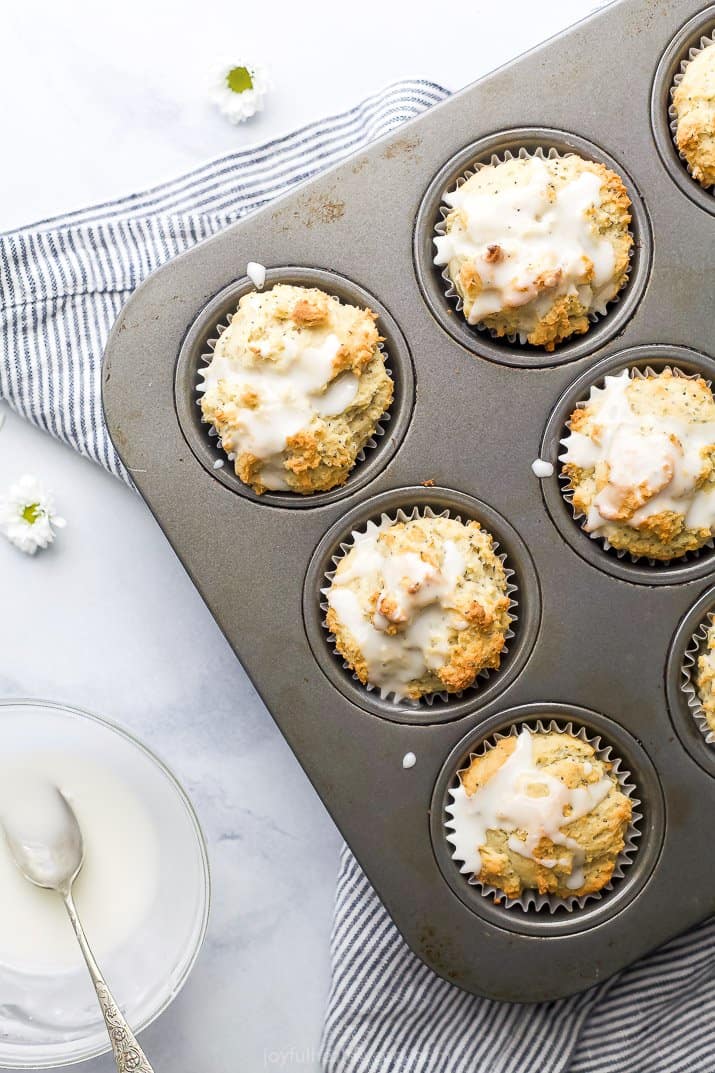 moist gluten free lemon poppyseed muffins in a muffin pan