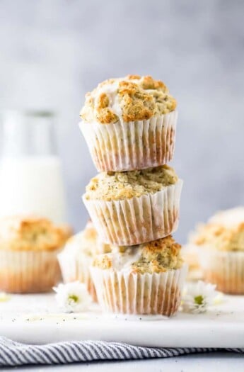 moist gluten free lemon poppyseed muffins piled on top of each other