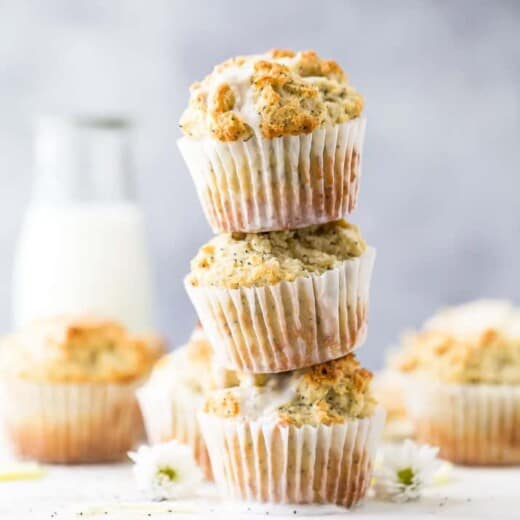 moist gluten free lemon poppyseed muffins piled on top of each other