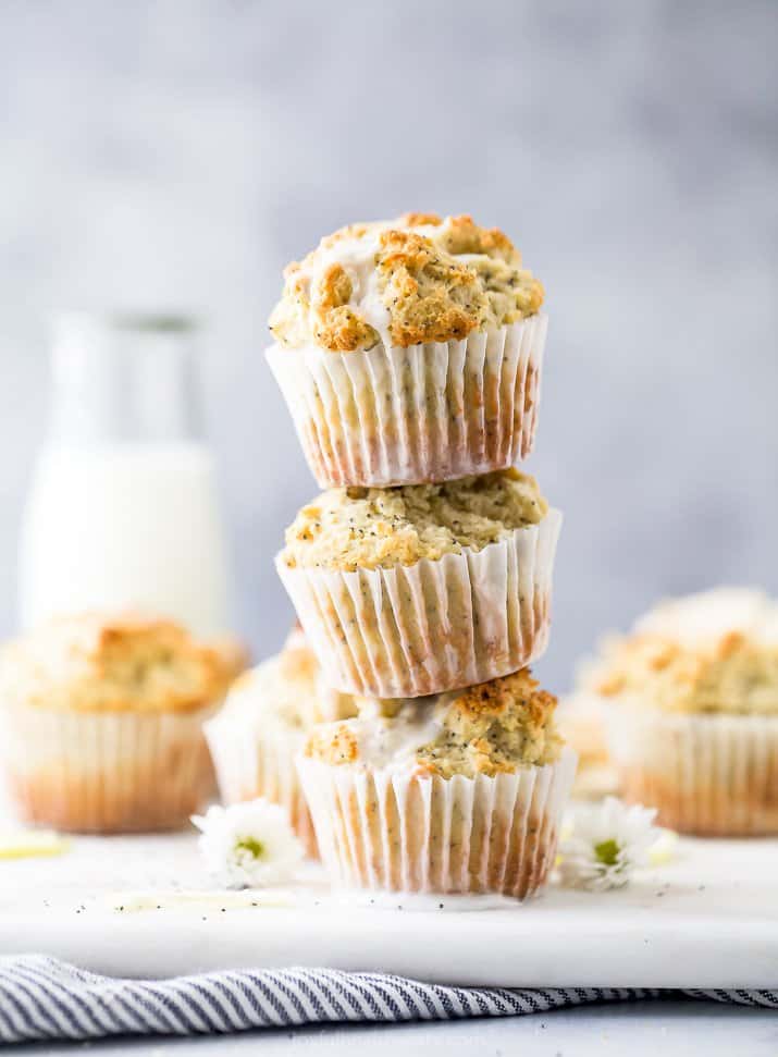 moist gluten free lemon poppyseed muffins piled on top of each other