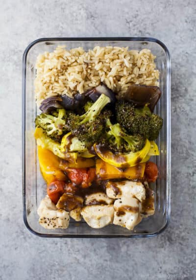 roasted veggie balsamic chicken grain bowls in a pyrex dish