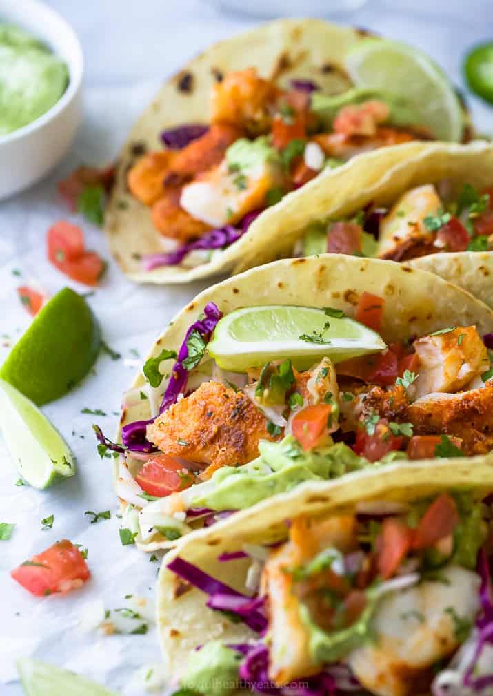 epic baja fish tacos topped with cabbage slaw and avocado crema