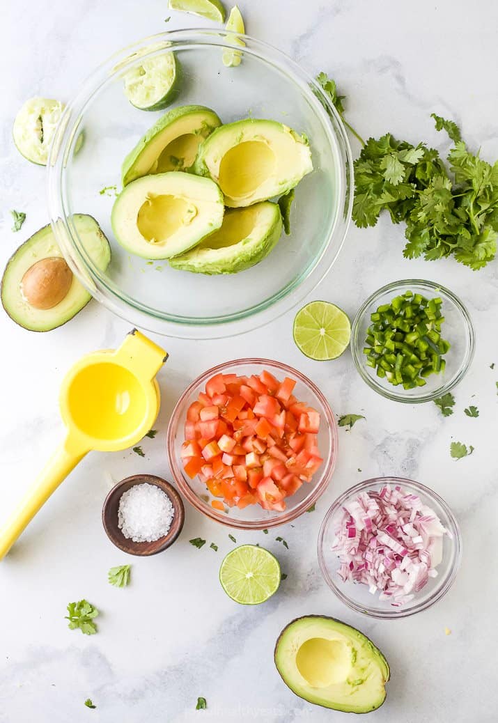 bowls with guacamole ingredients