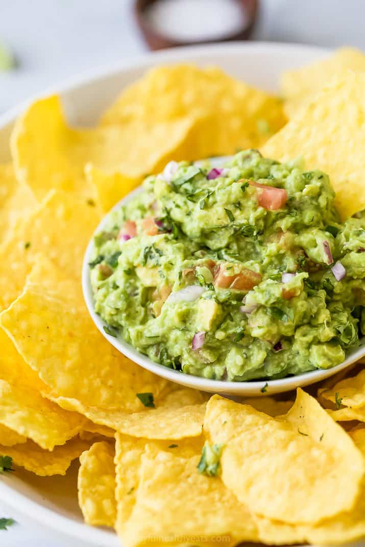 bowl filled with guacamole and chips