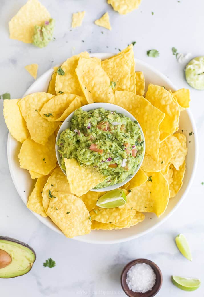 white bowl filled with chips and guacamole
