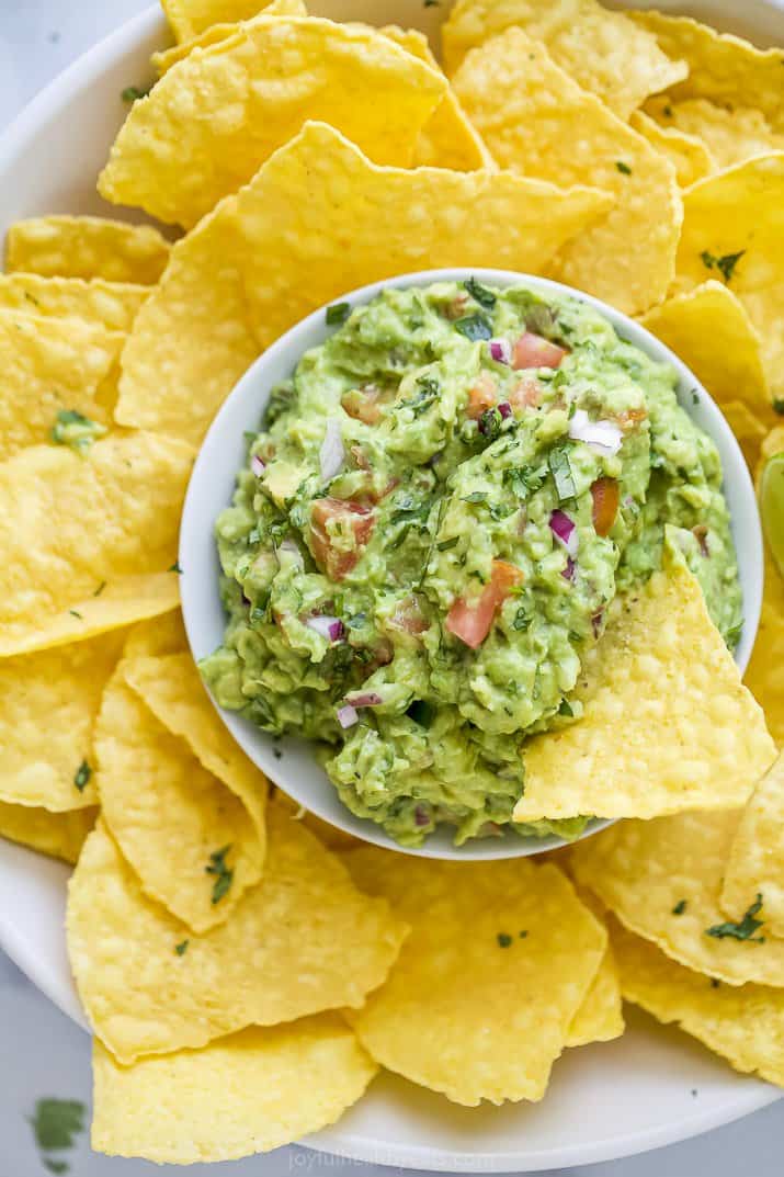 white plate with chips and guacamole