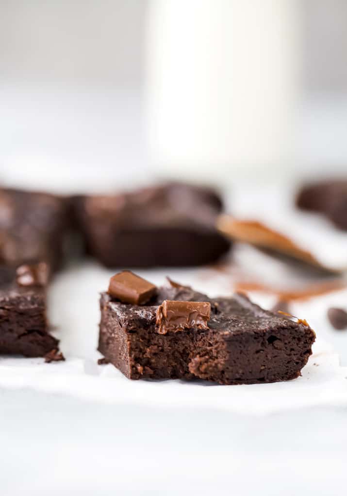 close up double chocolate avocado brownies with a bite in it