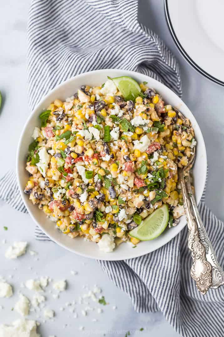 a bowl of grilled mexican street corn esquites salad topped with fresh cilantro