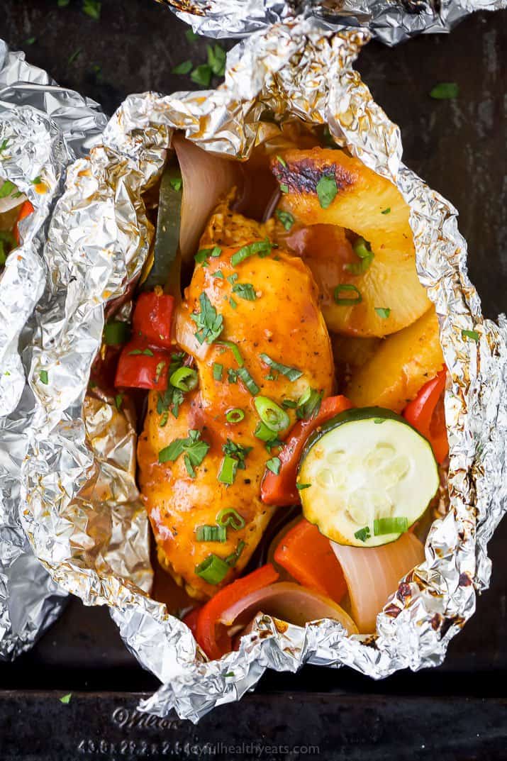 a foil packet filled with grilled hawaiian bbq chicken and vegetables