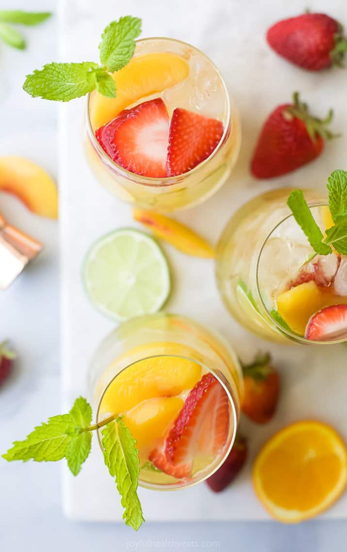 overhead photo of strawberry peach moscato sangria in wine glasses