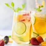 strawberry peach moscato sangria in a glass garnished with citrus