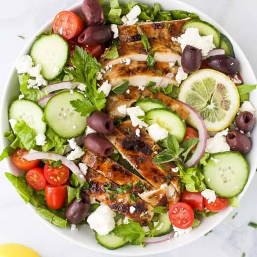 light greek salad with grilled chicken in a bowl