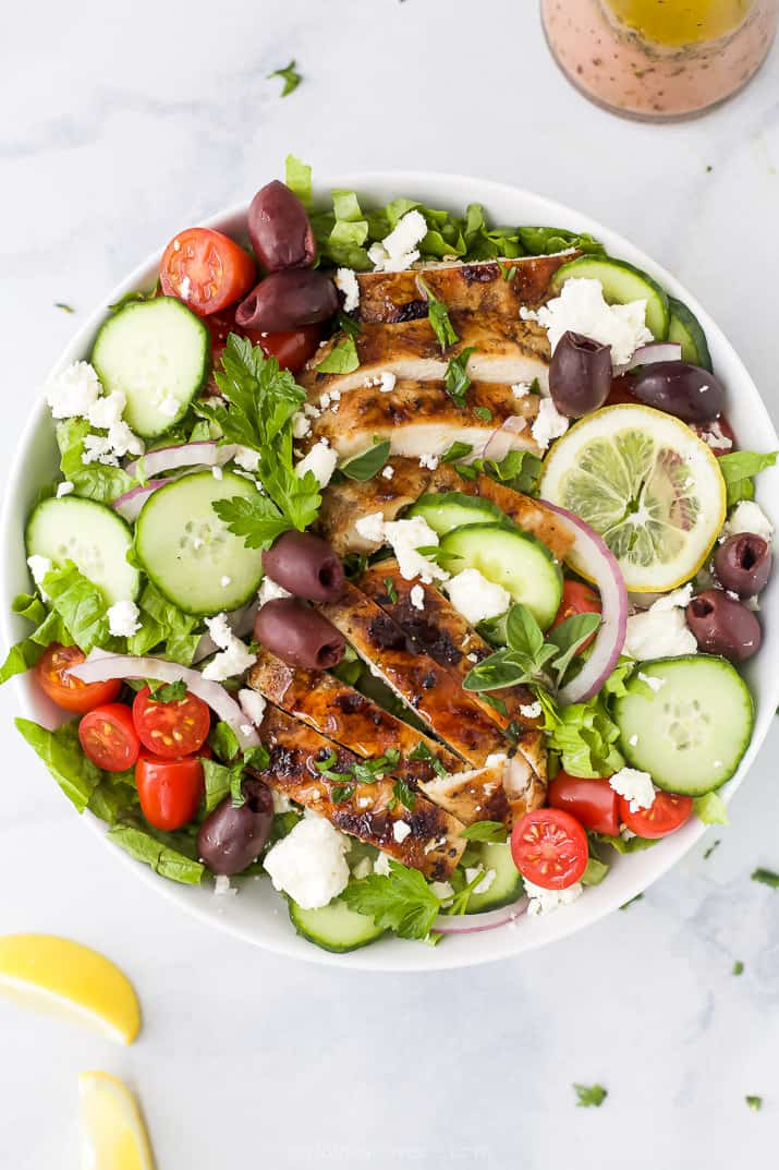 light greek salad with grilled chicken in a bowl