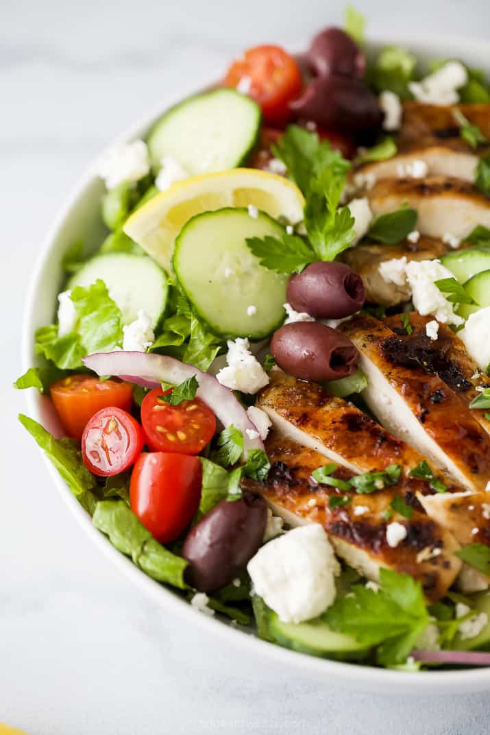 side photo of light greek salad with grilled chicken and greek salad