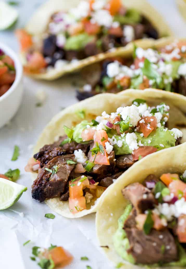 close up of best ever marinated carne asada tacos filled with avocado crema