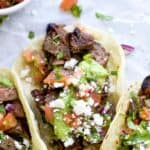 pinterest image for best ever marinated carne asada tacos