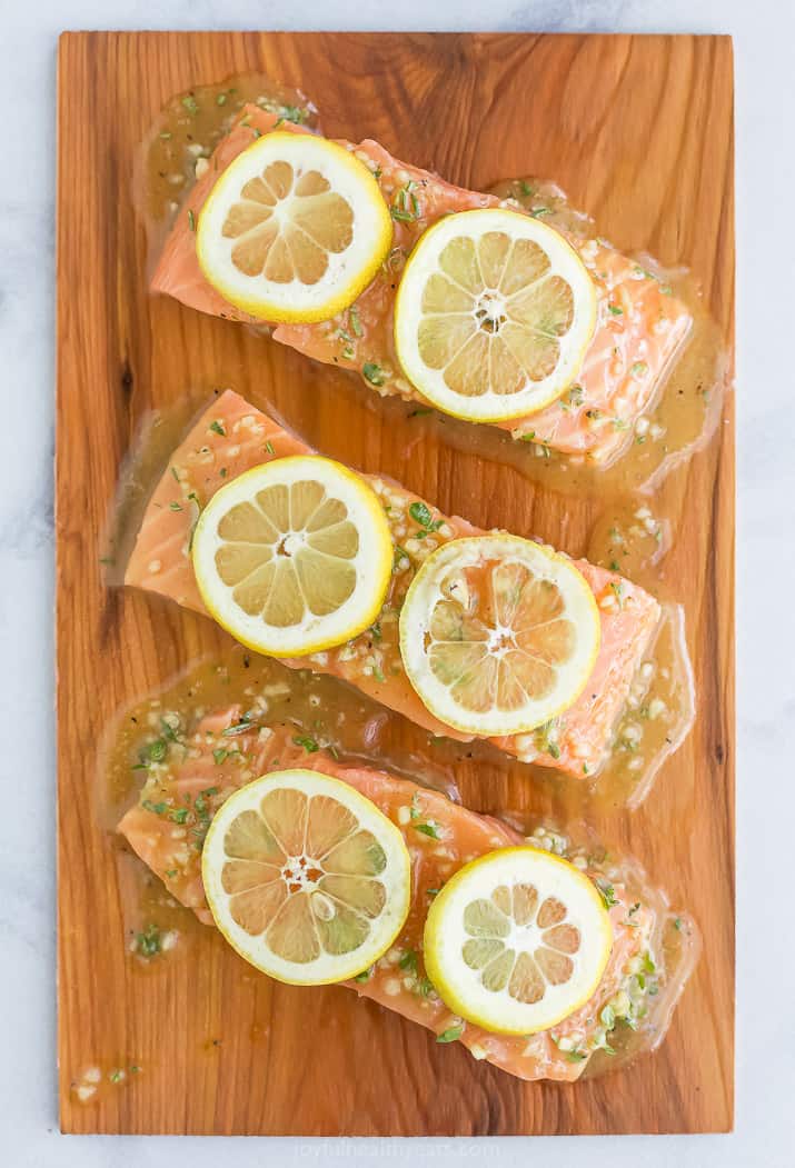 cedar plank salmon with honey garlic sauce and lemon slices on it