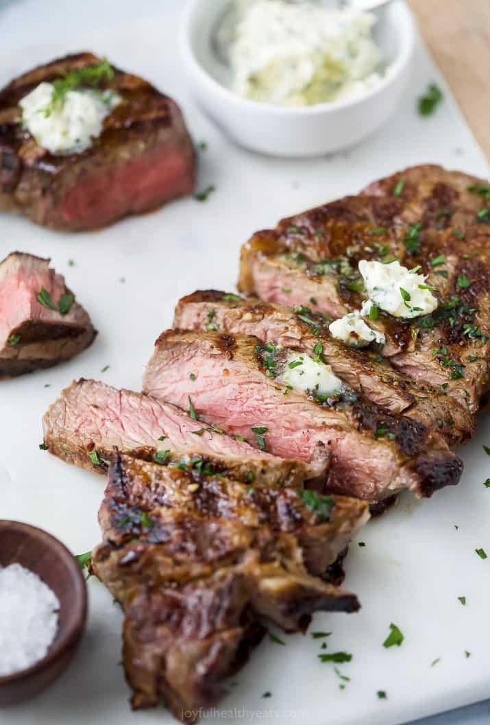 sliced grilled ribeye steak topped with garlic herb butter