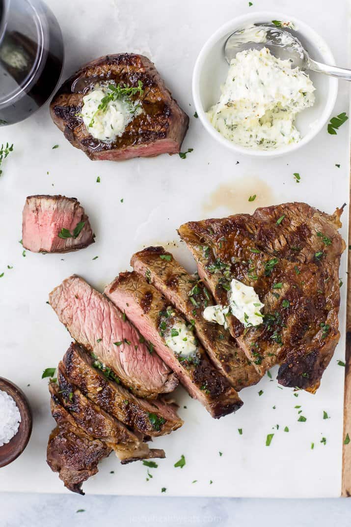 grilled ribeye steak and filet mignon with herb butter on top