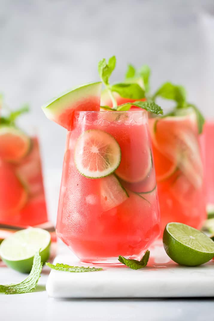 a glass filled with refreshing watermelon cucumber gin cocktail garnished with watermelon