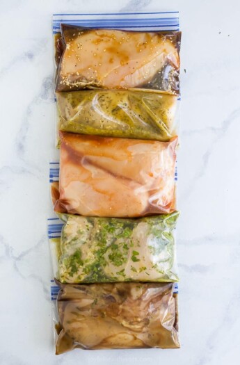 overhead photo of 5 chicken marinades for grilling in ziplock bags