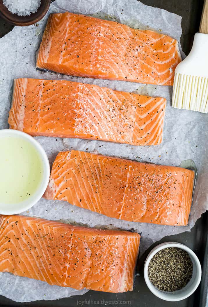 seasoned salmon fillets ready to be grilled