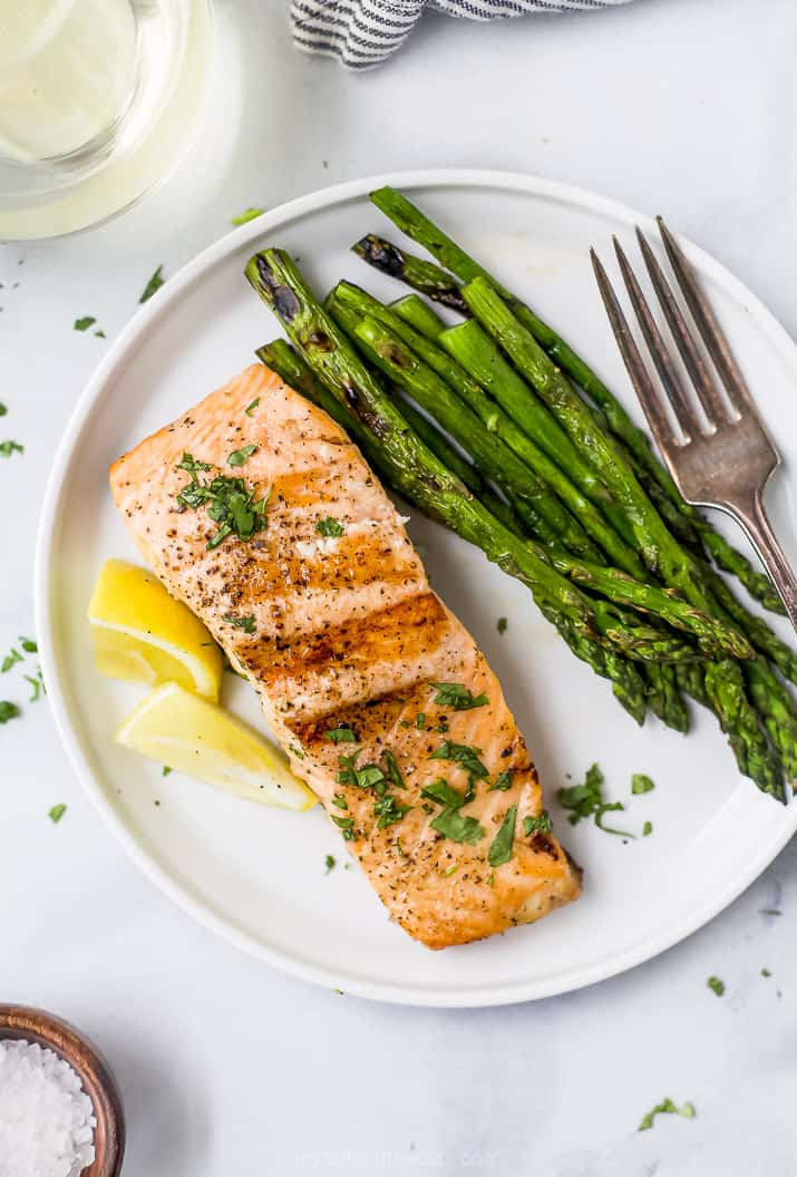 grilled salmon on a plate with grilled asparagus