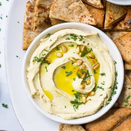 overhead view of homemade hummus recipe with baked pita chips