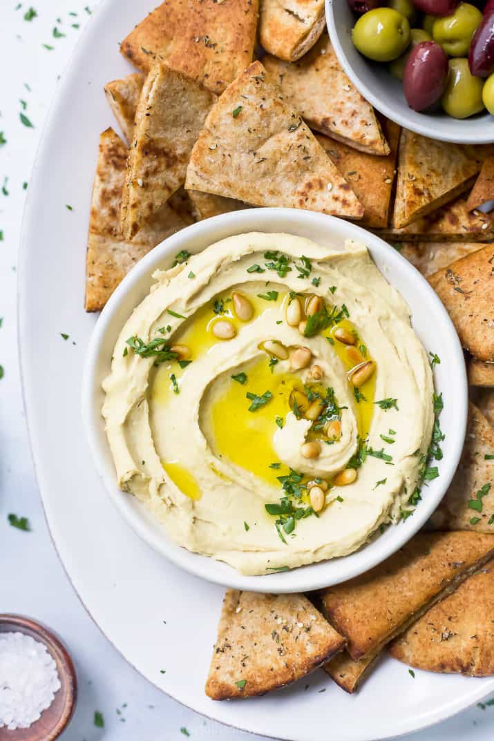 overhead view of homemade hummus recipe with baked pita chips