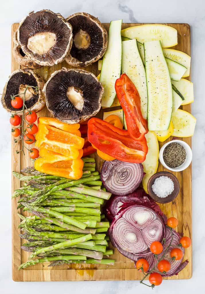 raw vegetables on a cutting board ready to grill