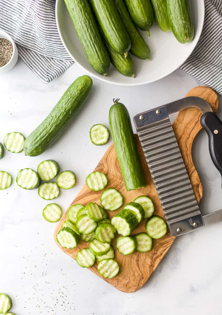 cucumbers sliced into coins on a cutting board