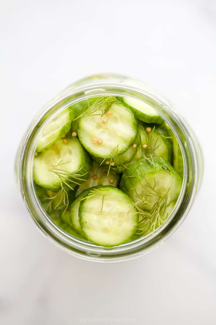 fresh cucumbers in a jar with pickling ingredients