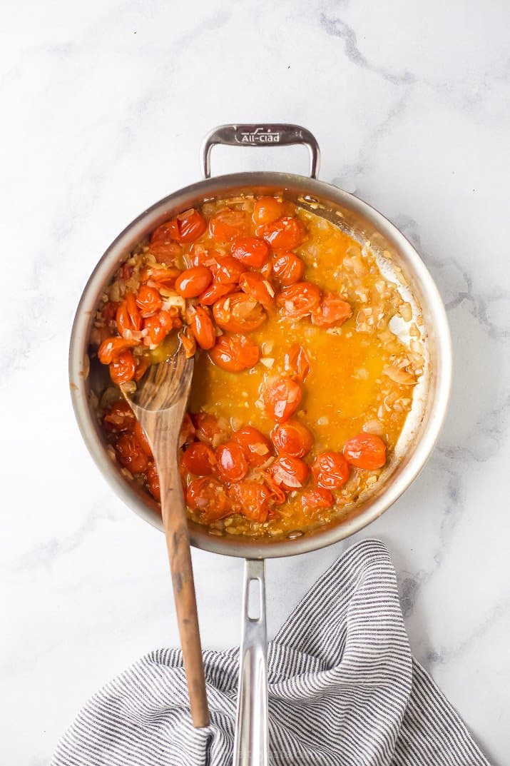 blistered tomatos in a skillet