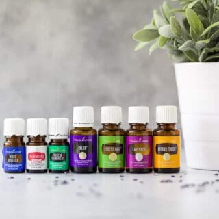 Seven bottles of Young Living essential oils for calming anxiety lined up together
