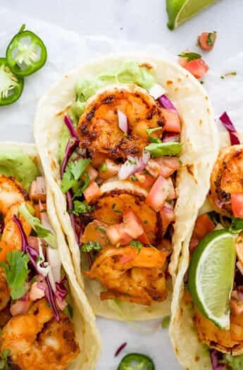 close up of a taco filled with pan seared shrimp and cilantro lime slaw