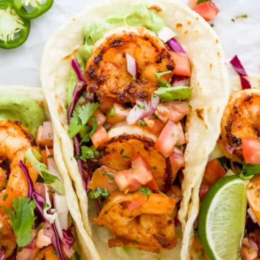 close up of a taco filled with pan seared shrimp and cilantro lime slaw