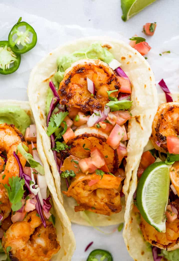 close up of a taco filled with pan seared shrimp and cilantro lime slaw