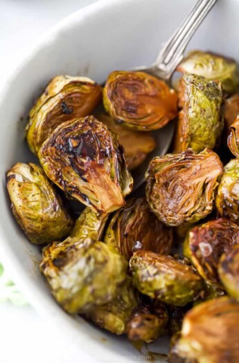 closet up of oven roasted brussel sprouts with balsamic in a bowl