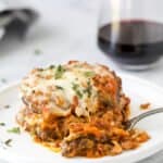 eggplant parmesan on a plate with a fork