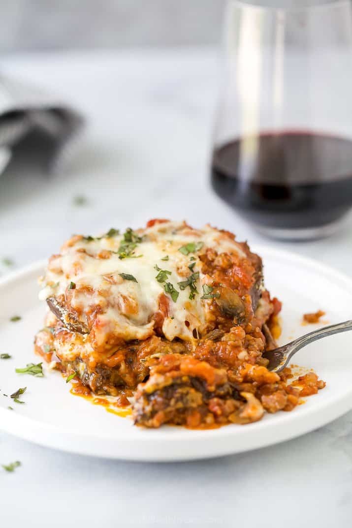 eggplant parmesan on a plate with a fork