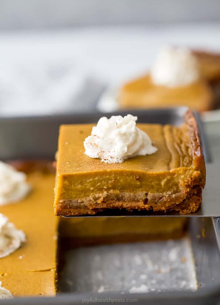 a spatula lifting up a pumpkin pie bar