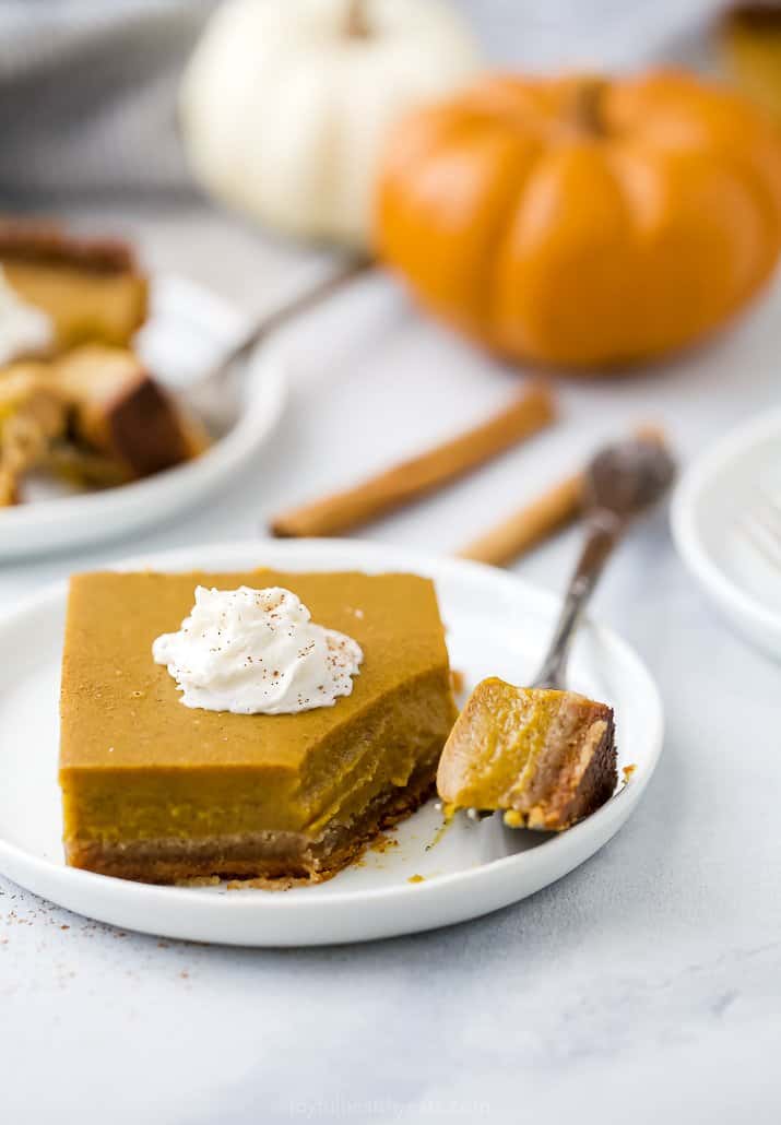 a plate with pumpkin pie bars with a fork on it