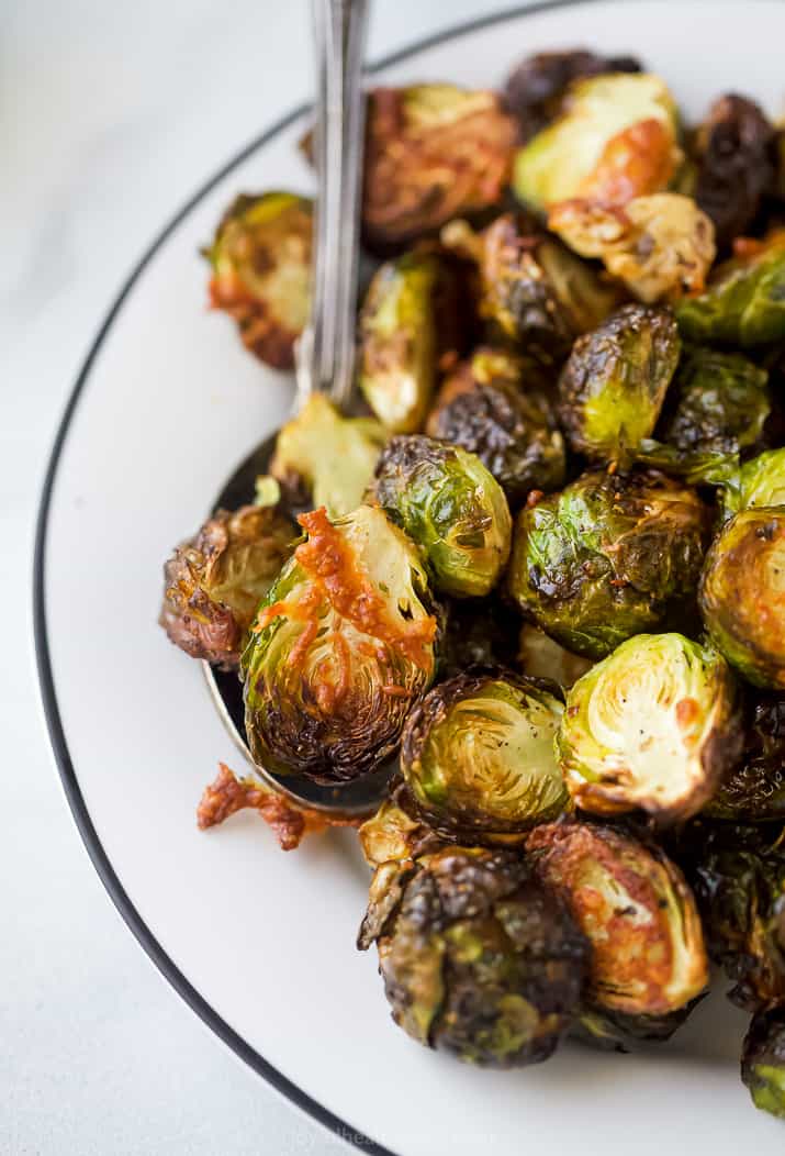 spoon scooping crispy brussel sprouts
