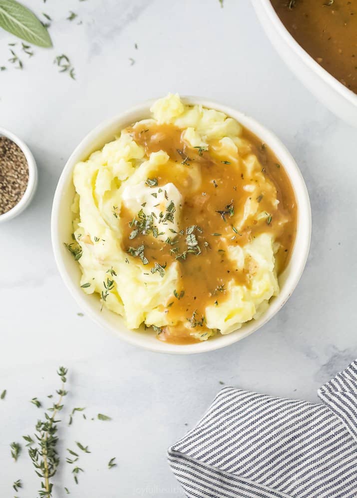 a bowl filled with mashed potatoes covered in gravy