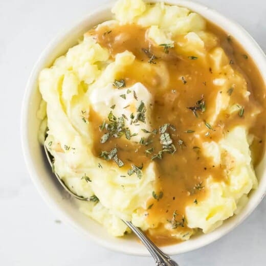 bowl filled with mashed potatoes covered in gravy