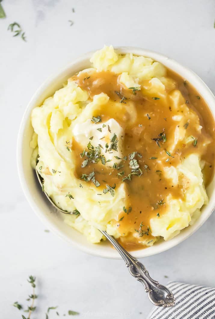 bowl filled with mashed potatoes covered in gravy