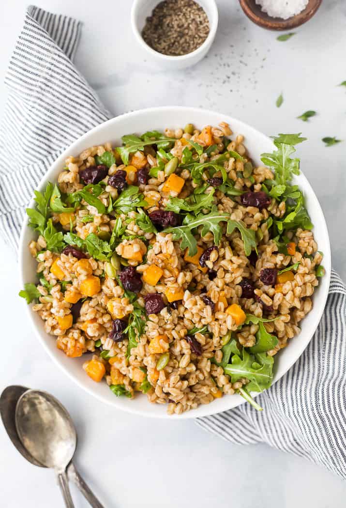 a bowl filled with farro salad with butternut squash