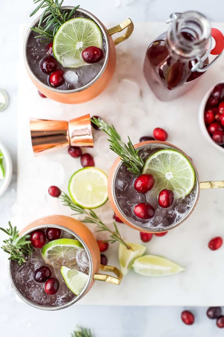 copper cups filled with cranberry moscow mule