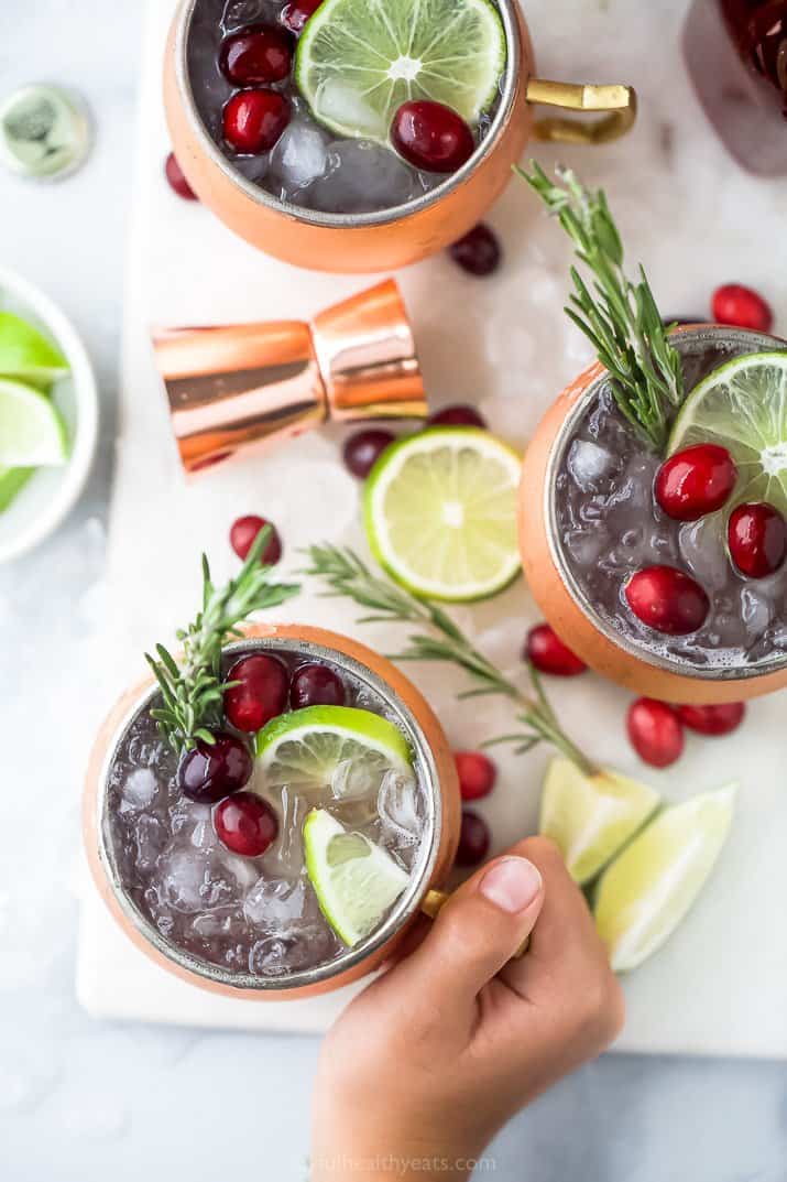hand holding a mug with cranberry moscow mule