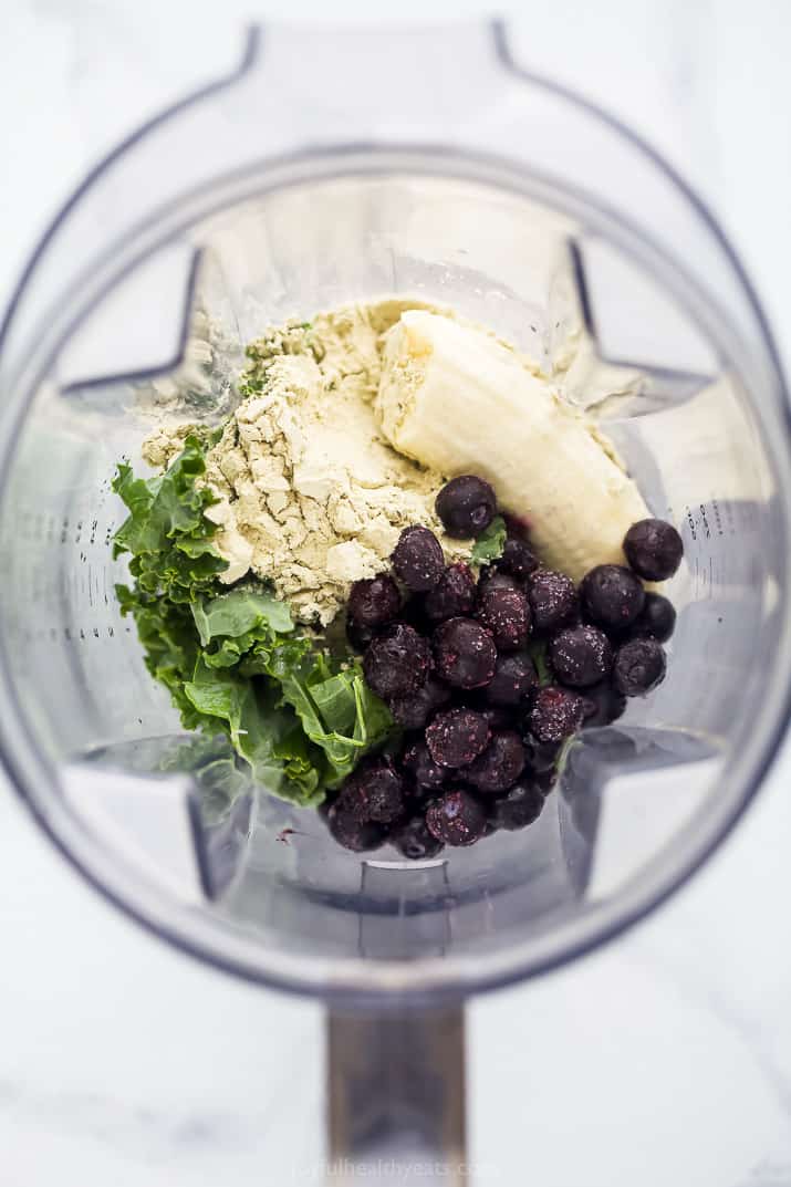 A Blender Filled with Fruit, Kale and Protein Powder